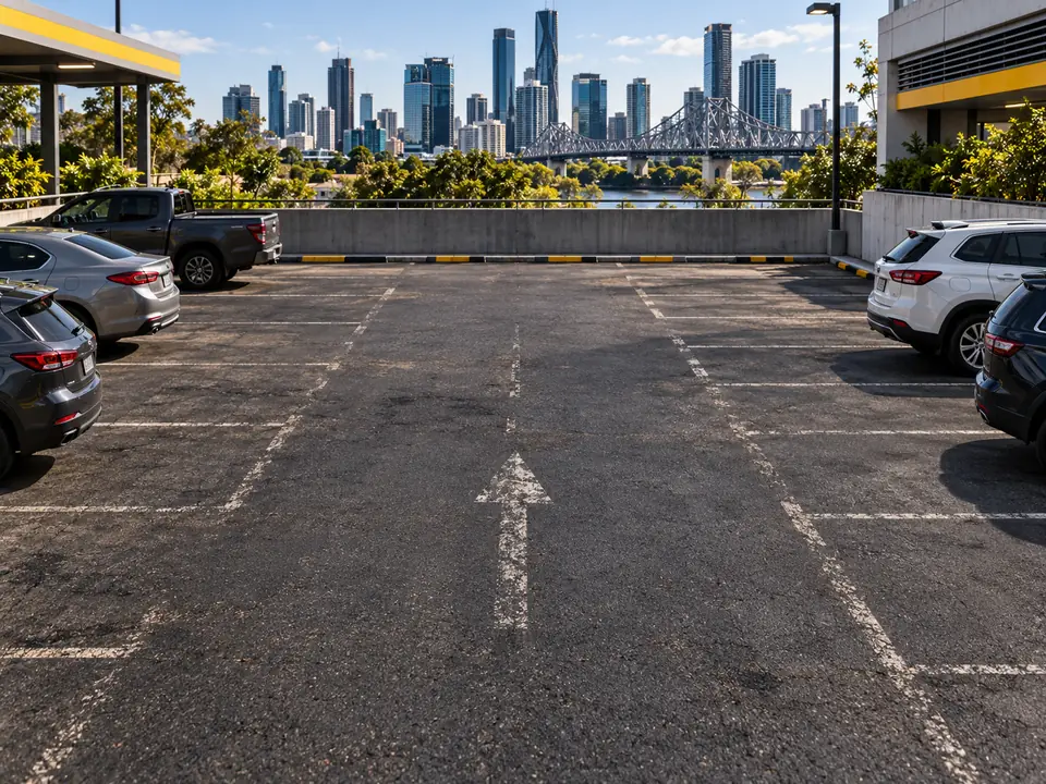 Faded car park line marking on an asphalt parking area